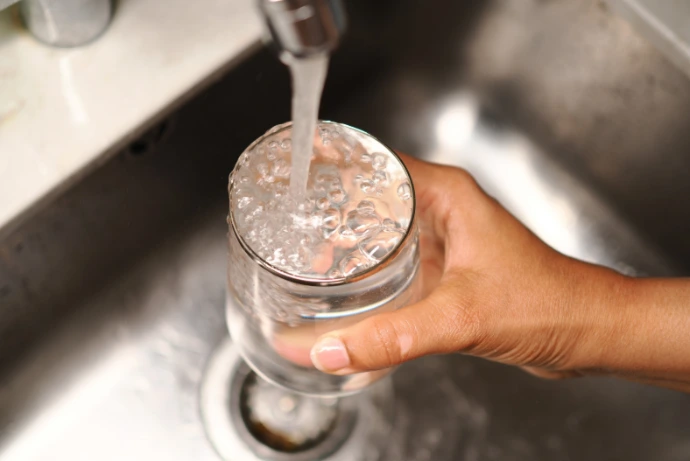 Glass being filled with water from tap for drinking